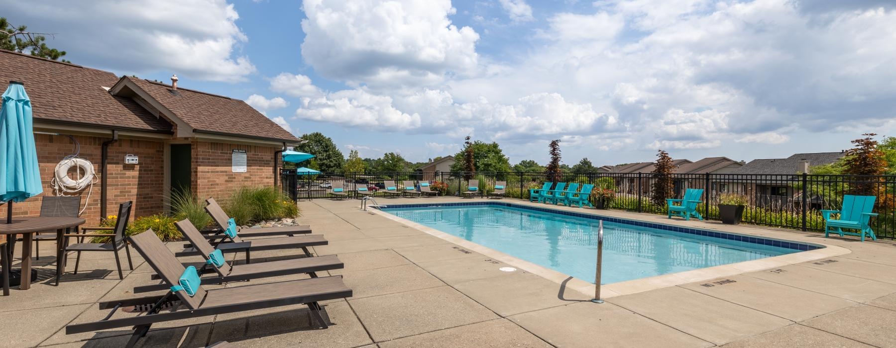 a pool with chairs around it