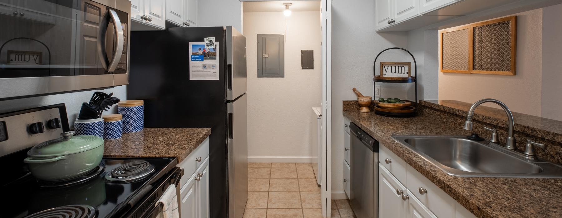 a kitchen with white cabinets