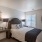 a bedroom with a bed and a mirror