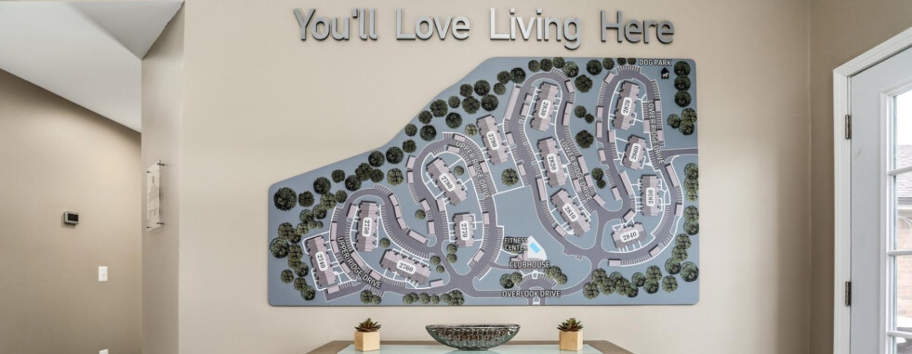 a table with a large map of the property on the wall